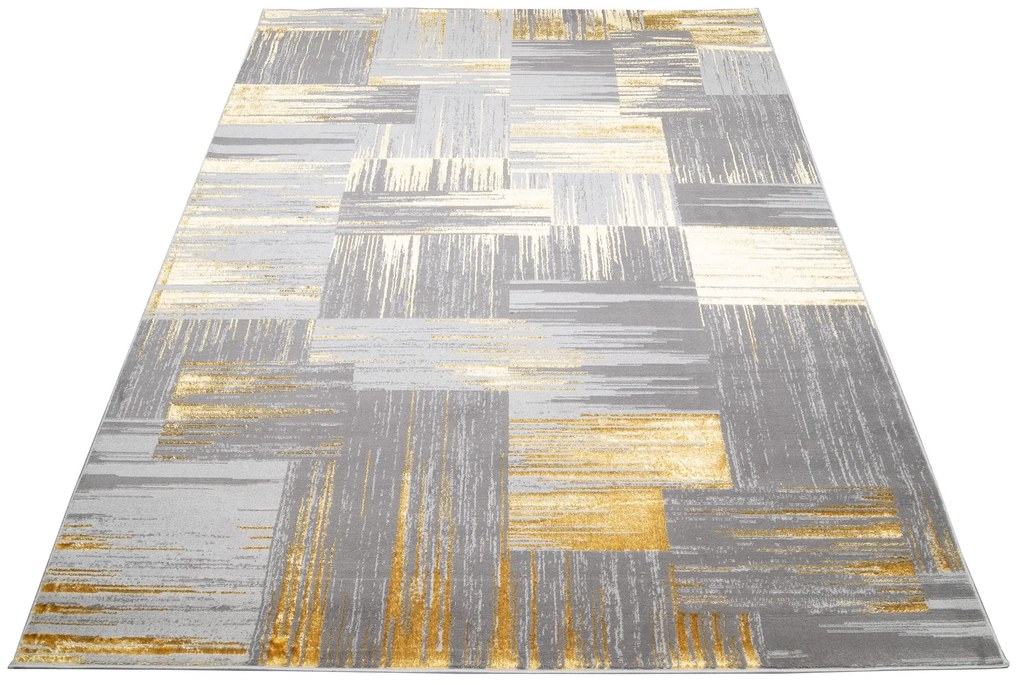 Moderný sivý koberec do obývačky so zlatým motívom