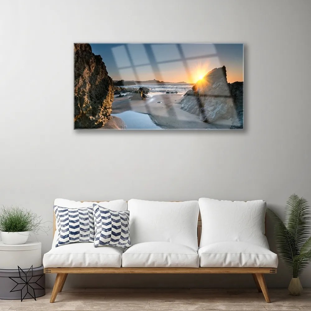 Skleneny obraz Skala pláž slnko krajina 140x70 cm
