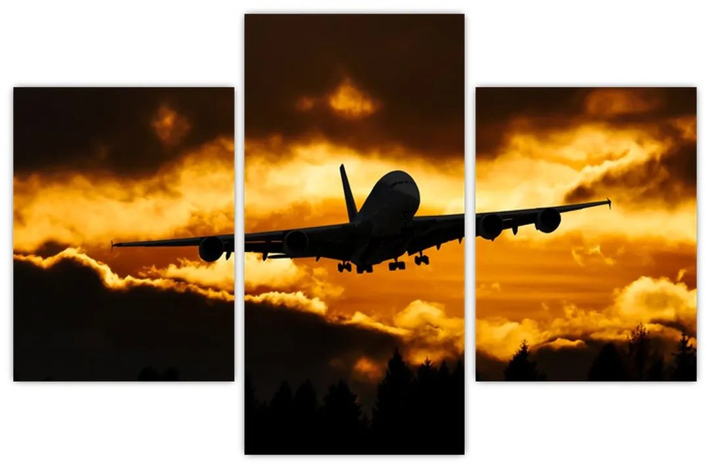 Pristávajúce lietadlo pri západe slnka - obraz