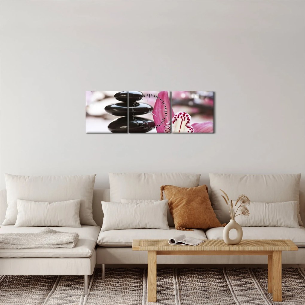 Obraz masážnych kameňov a orchidey na vode (s hodinami) (90x30 cm)