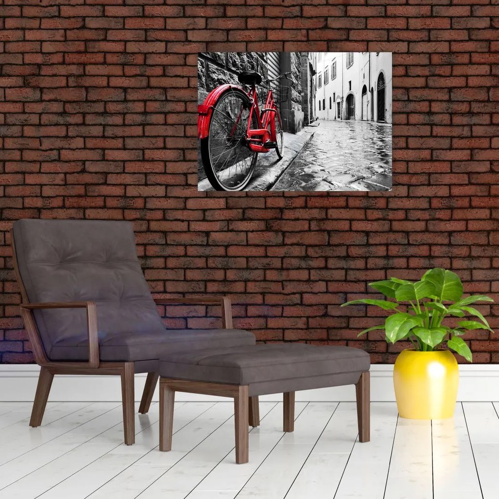 Sklenený obraz červeného kolesa na dláždenej ulici (70x50 cm)