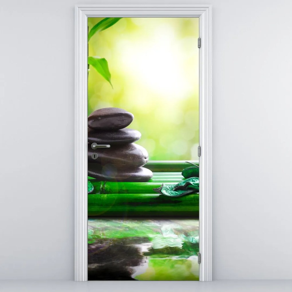 Fototapeta na dvere - Masážne kamene a orchidea na vode (95x205cm)