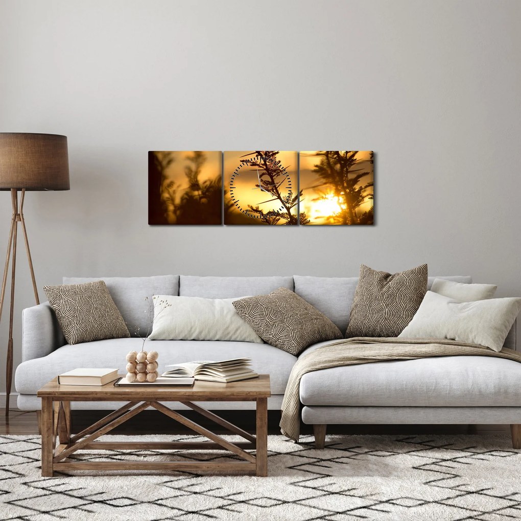 Obraz - Slnko zapadajúce za stromami (s hodinami) (90x30 cm)