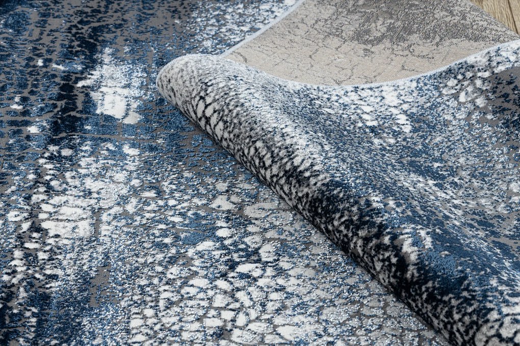 Moderný koberec DE LUXE 528 Abstrakcia - Štrukturálny krém / tmavomodrý