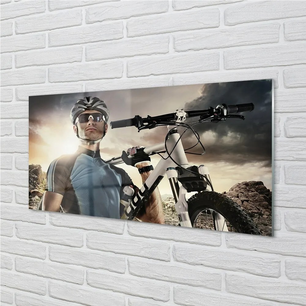 Obraz na skle Cyklista na bicykli mraky 120x60 cm