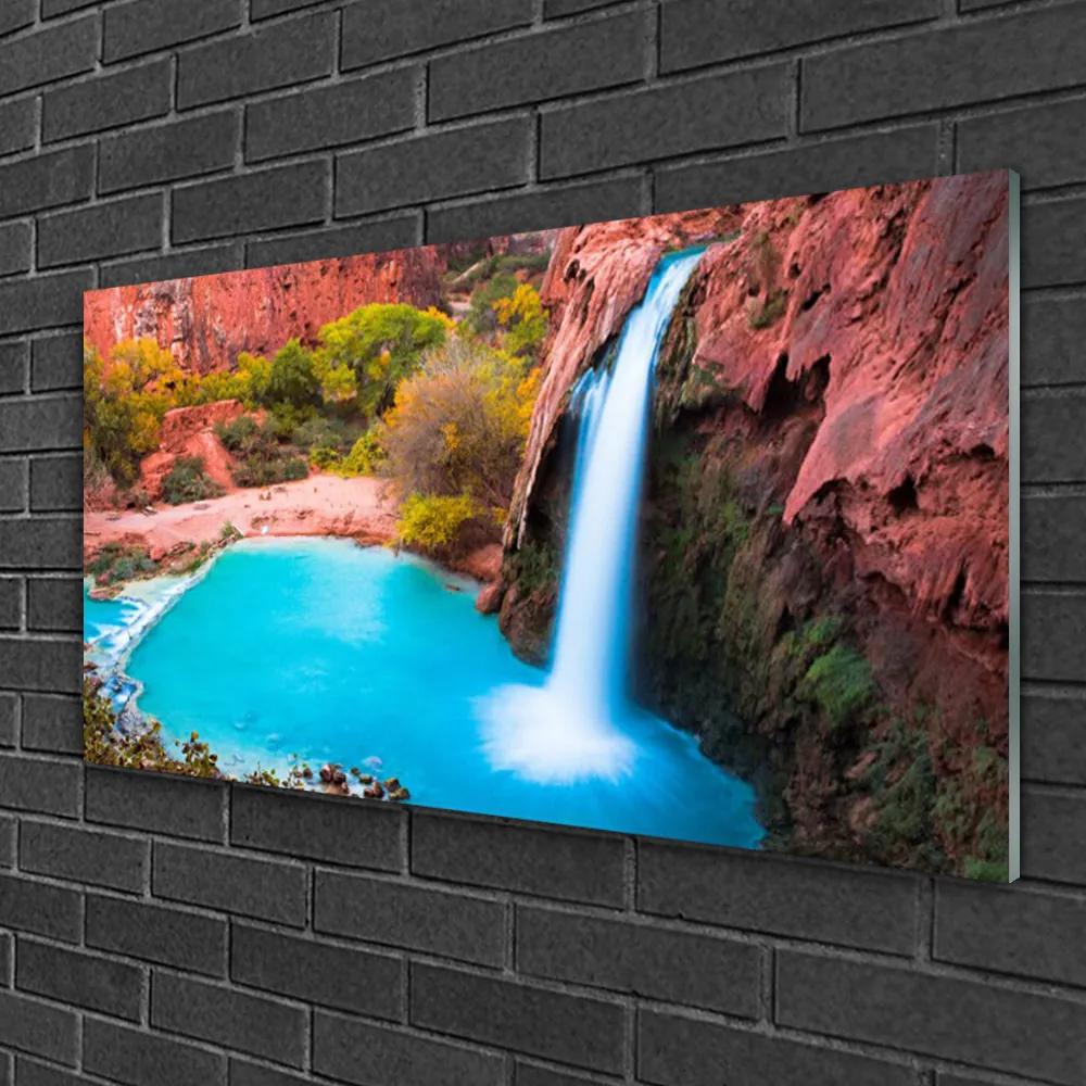 Obraz na skle Vodopád hory príroda 100x50 cm