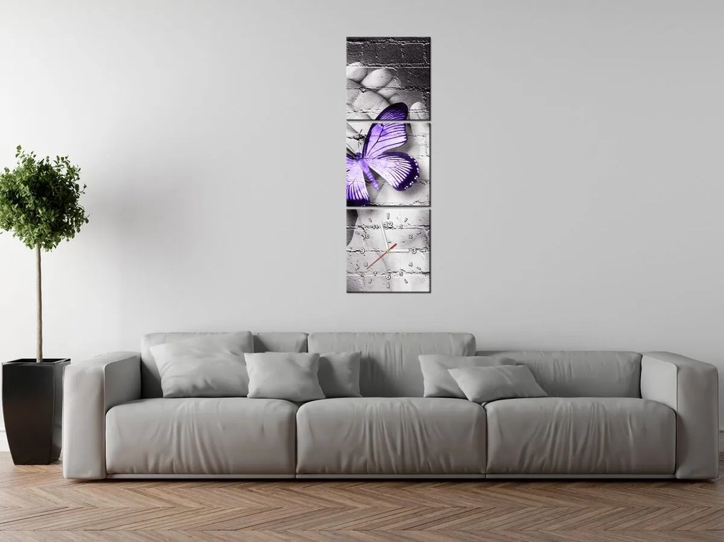 Gario Obraz s hodinami Fialový motýľ na dlaniach - 3 dielny Rozmery: 30 x 90 cm