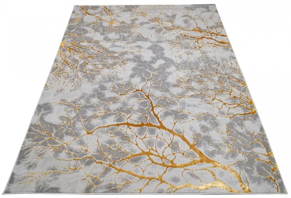 Jednoduchý moderný koberec sivej farby so zlatým motívom Šírka: 80 cm | Dĺžka: 150 cm