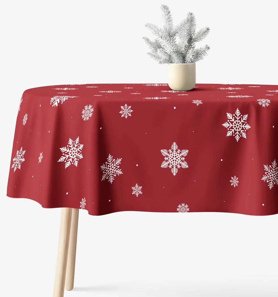 Goldea vianočný oválny obrus 100% bavlnené plátno - snehové vločky na červenej 120 x 160 cm
