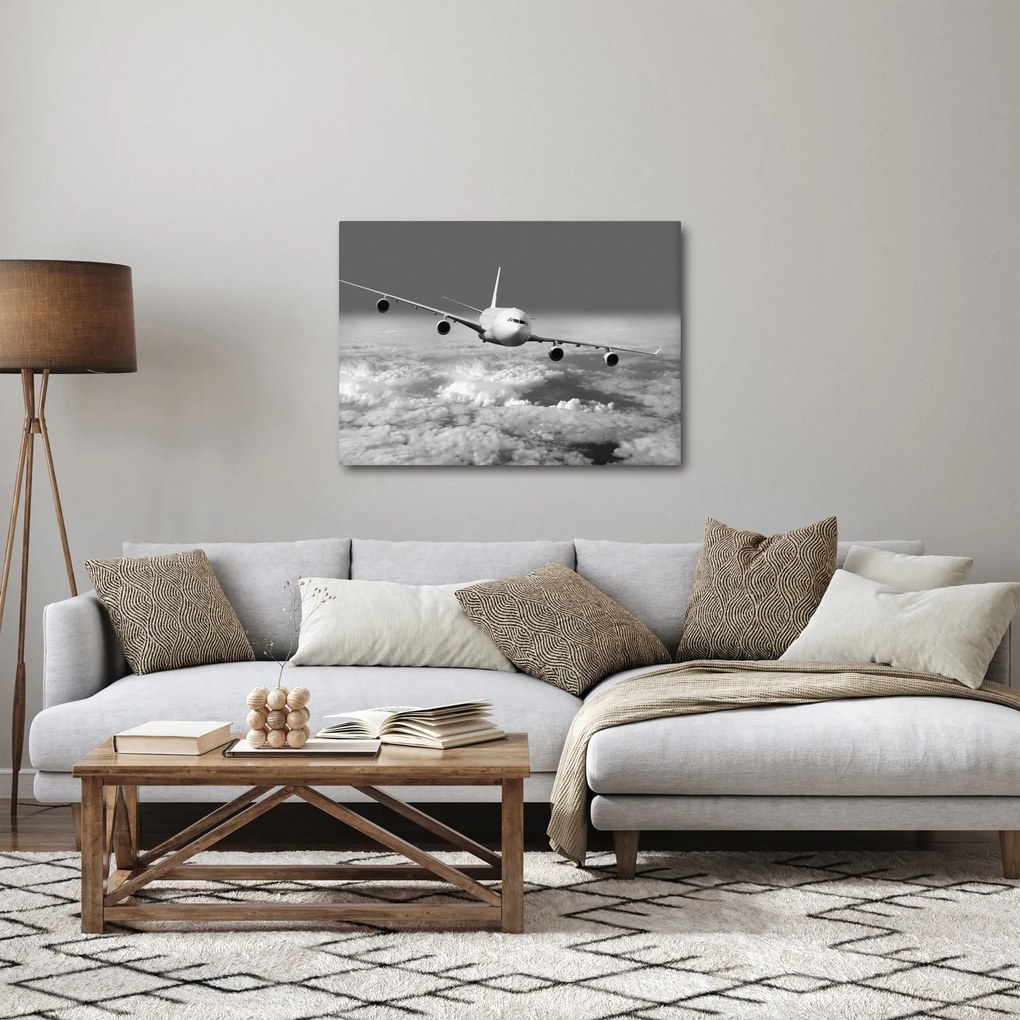 Obraz - Lietadlo v oblakoch, čiernobiele (70x50 cm)