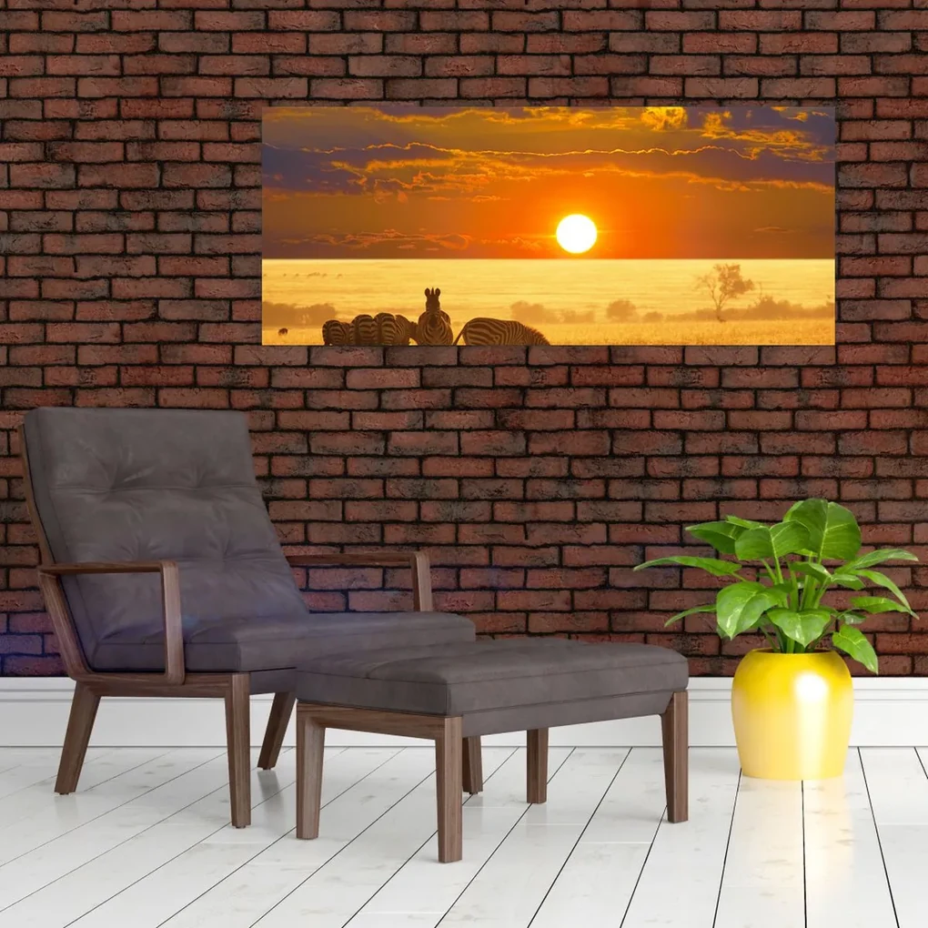 Obraz - Zebry so západom slnka (120x50 cm)