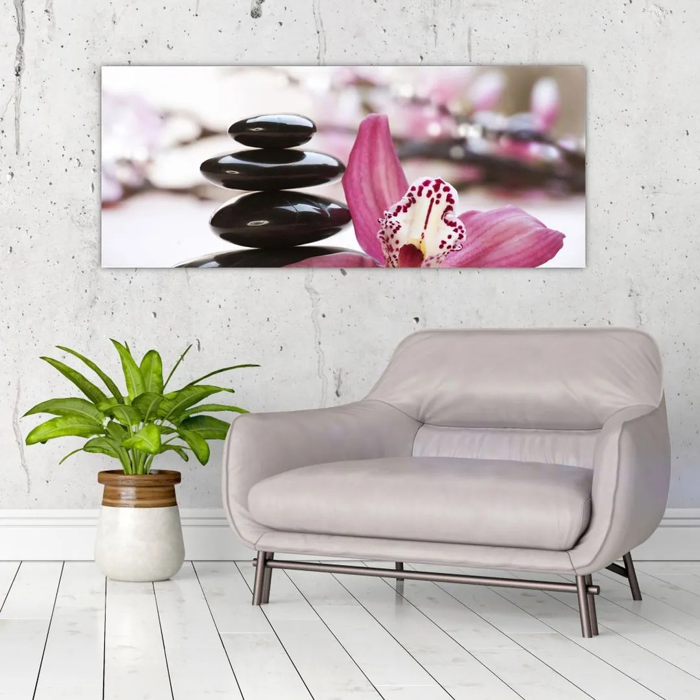 Obraz masážnych kameňov a orchidey na vode (120x50 cm)