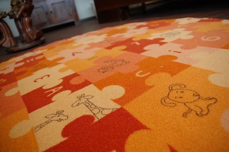 Detský guľatý koberec PUZZLE oranžový