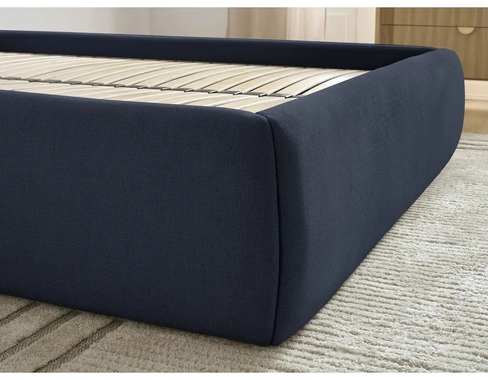 Tmavomodrá čalúnená dvojlôžková posteľ s úložným priestorom/bez čela s roštom 180x200 cm Inera – Bobochic Paris