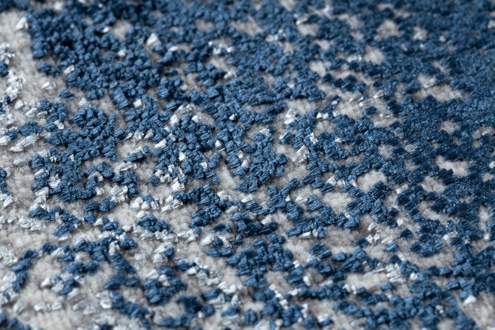 Moderný koberec DE LUXE 528 Abstrakcia - Štrukturálny krém / tmavomodrý