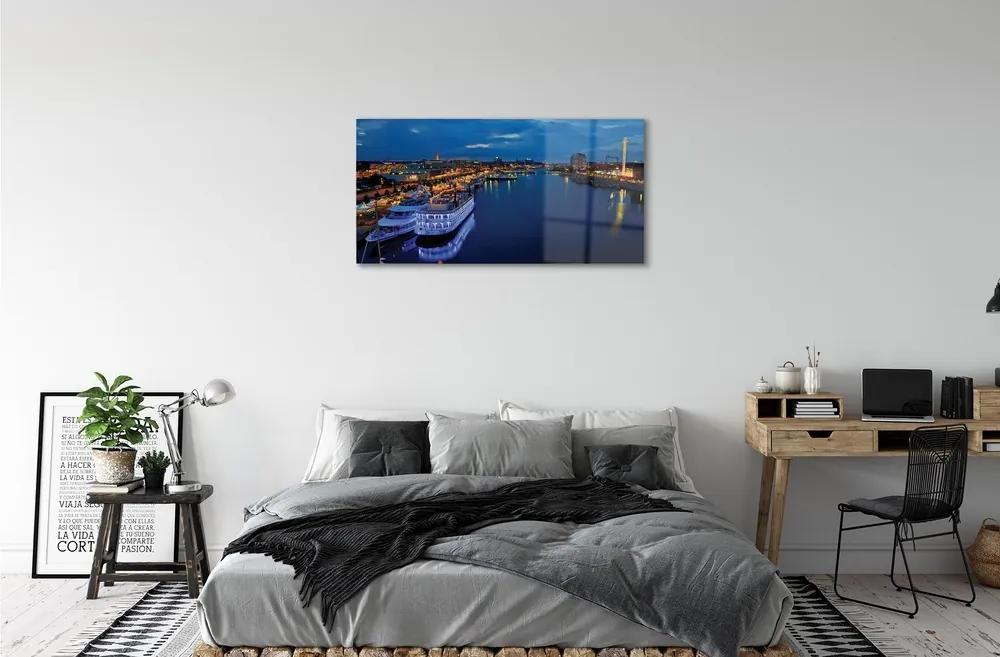 Obraz na skle Loď mora mesto na nočnej oblohe 100x50 cm
