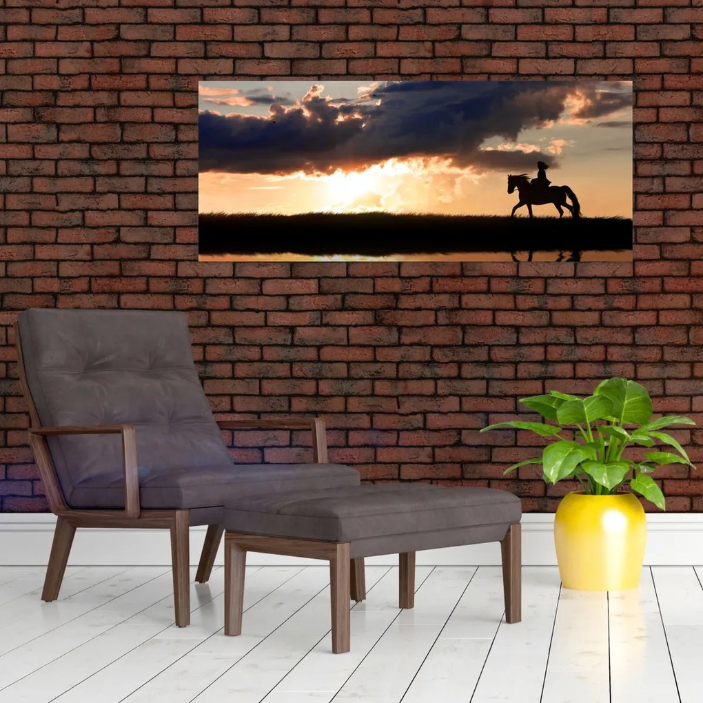 Obraz - Jazdec na koni pri západe slnka (120x50 cm)