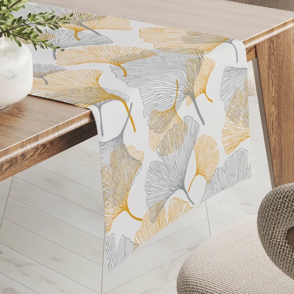Biante Bavlnený behúň na stôl Sandra SA-745 Sivo-horčicové ginkgo listy na bielom 20x140 cm