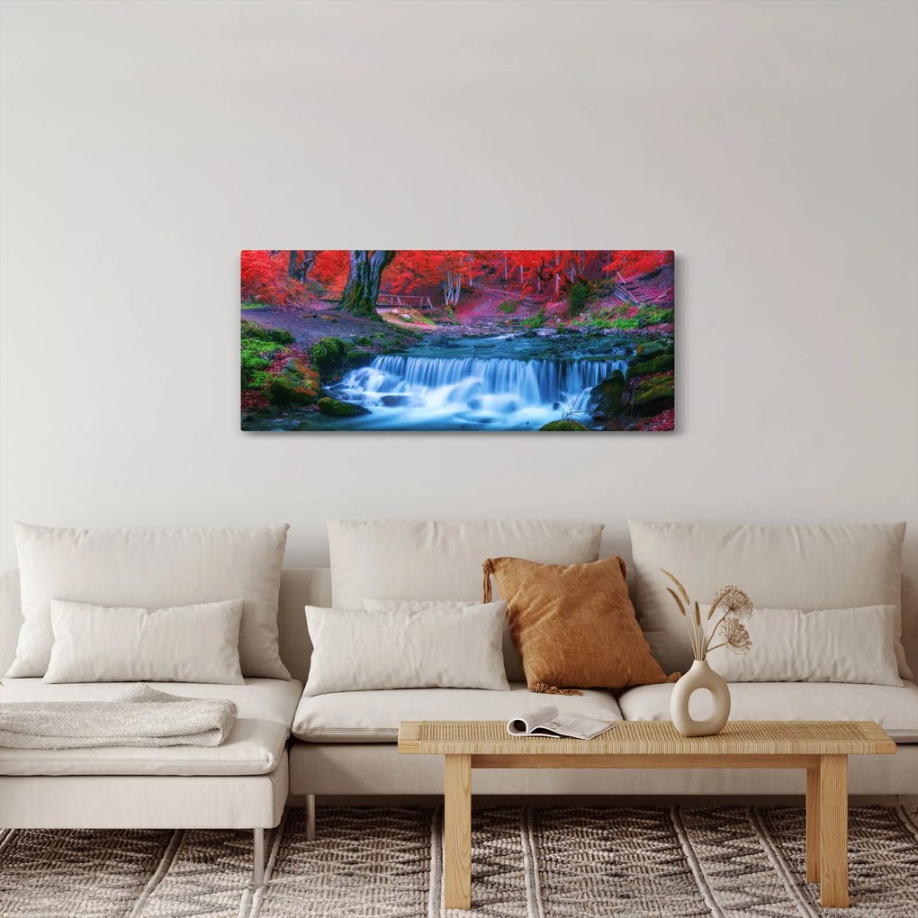 Obraz vodopádu v červenom lese (120x50 cm)
