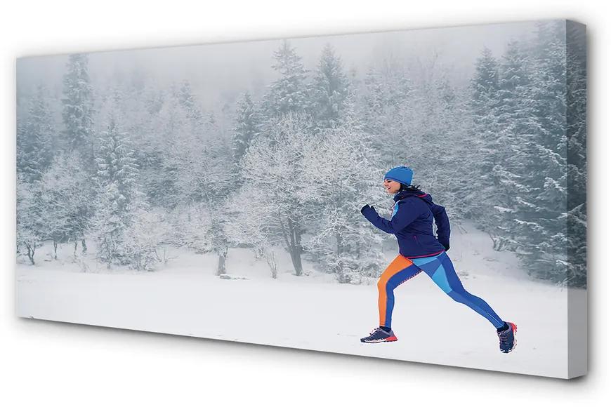 Obraz canvas Les v zime sneh muž 100x50 cm