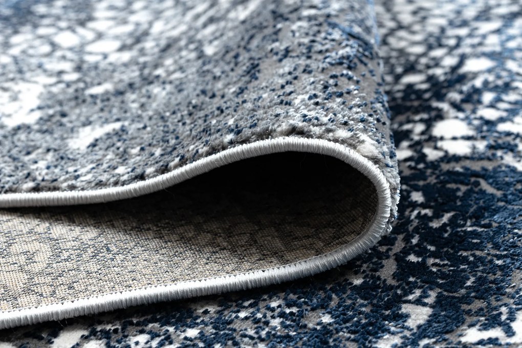 Moderný koberec DE LUXE 528 Abstrakcia - Štrukturálny krém / tmavomodrý