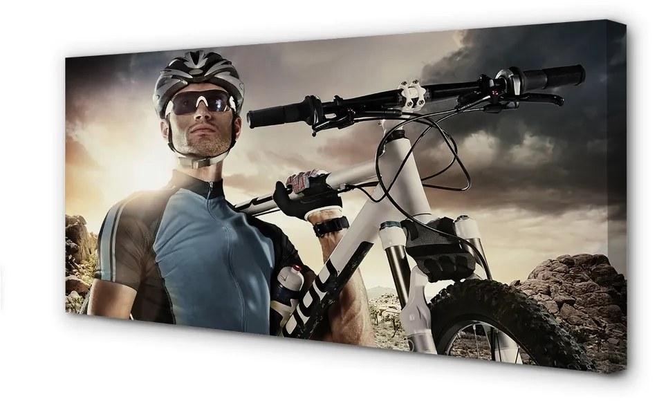 Obraz canvas Cyklista na bicykli mraky 125x50 cm