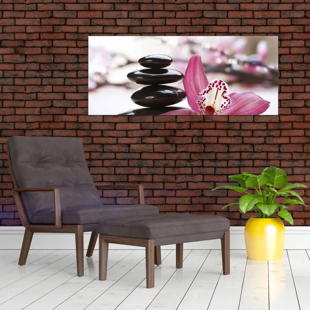 Obraz masážnych kameňov a orchidey na vode (120x50 cm)