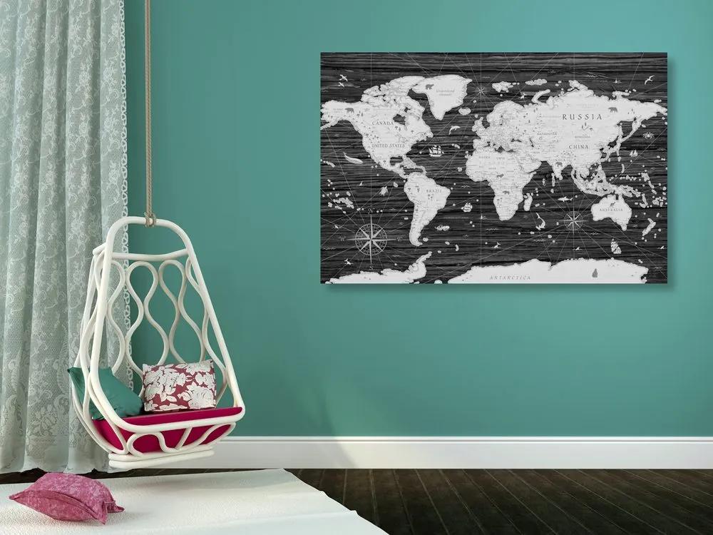 Obraz historická mapa sveta na drevenom pozadí v čiernobielom prevedení
