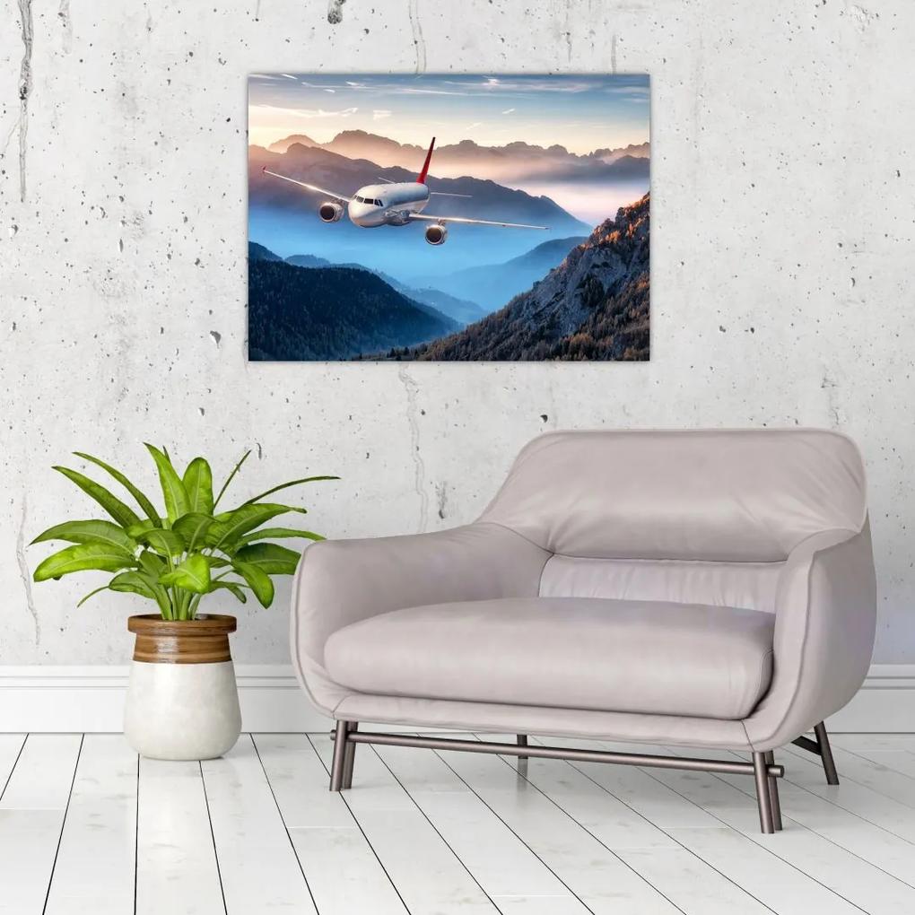Sklenený obraz - Lietadlo nad vrcholmi hôr (70x50 cm)