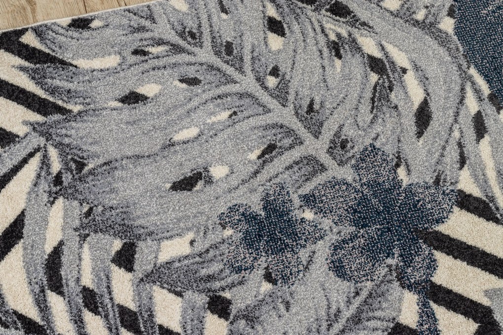 Koberec HEOS 78540 krémovo / modrý LISTY DŽUNGLE