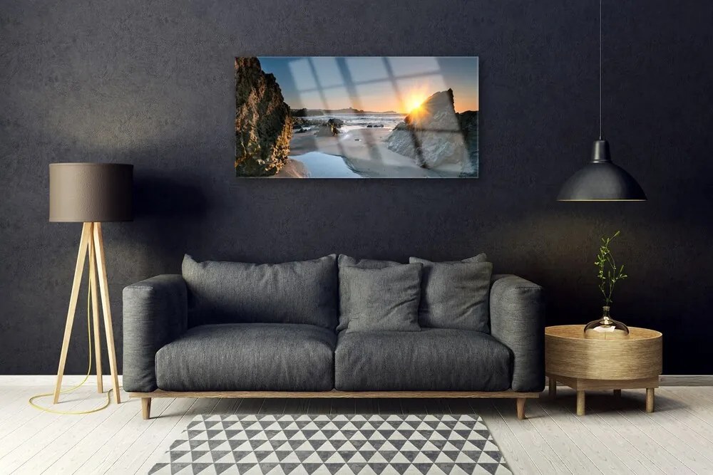 Skleneny obraz Skala pláž slnko krajina 100x50 cm