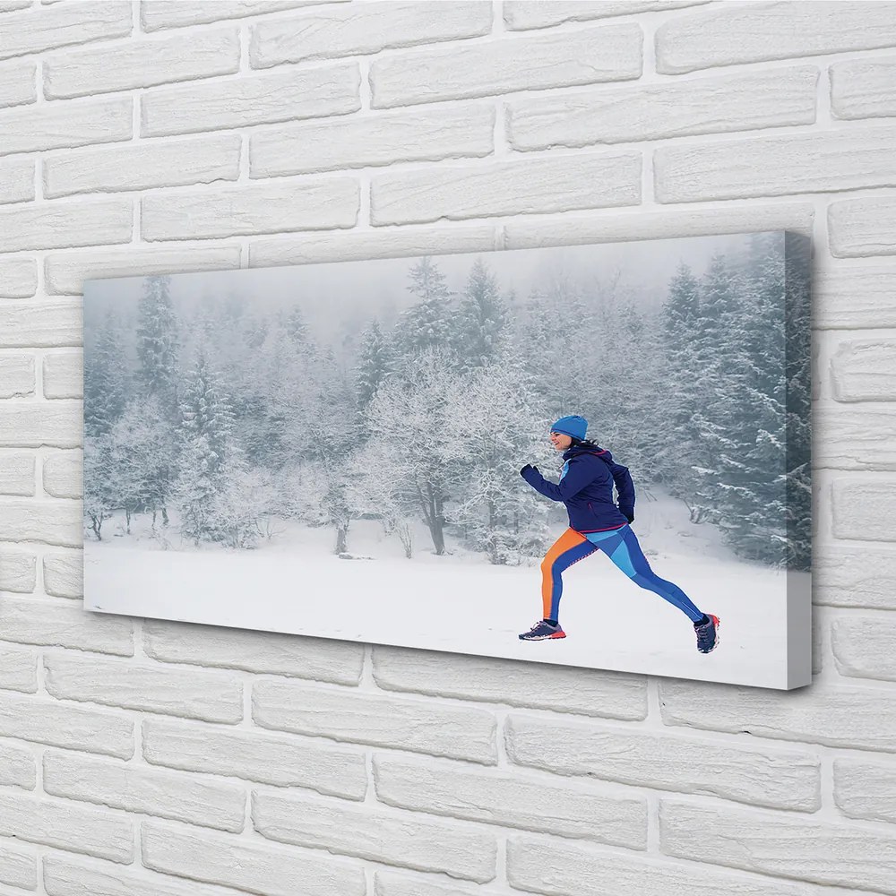 Obraz canvas Les v zime sneh muž 140x70 cm