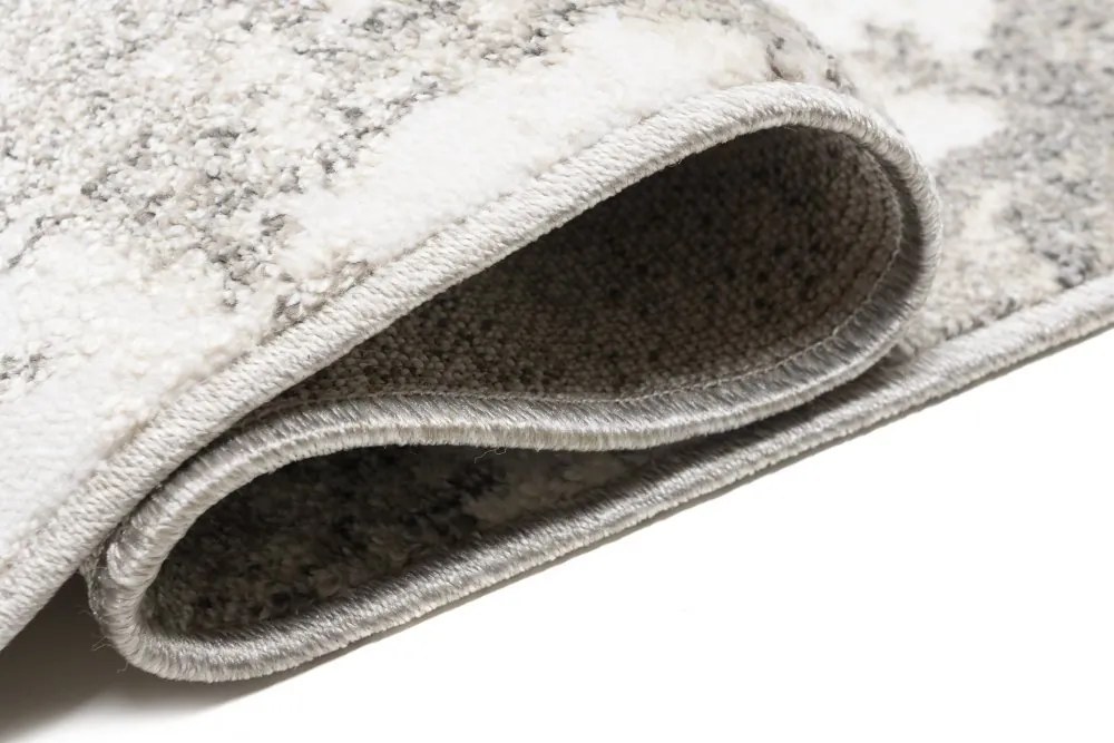 Dizajnový koberec s abstraktným vzorom v krémovej farbe Šírka: 80 cm | Dĺžka: 150 cm