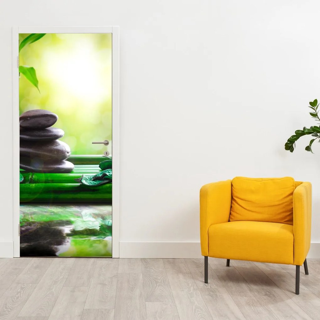Fototapeta na dvere - Masážne kamene a orchidea na vode (95x205cm)