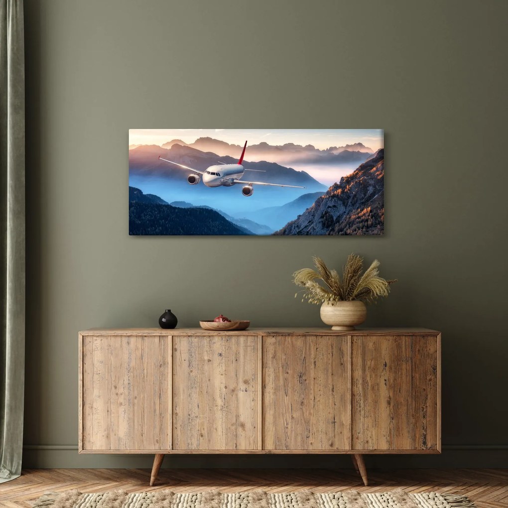 Obraz - Lietadlo nad vrcholmi hôr (120x50 cm)