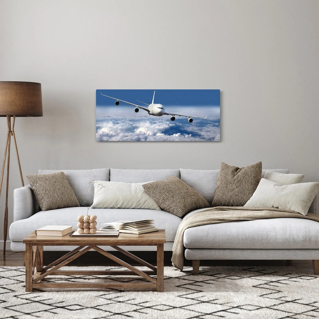 Obraz - Lietadlo v oblakoch (120x50 cm)