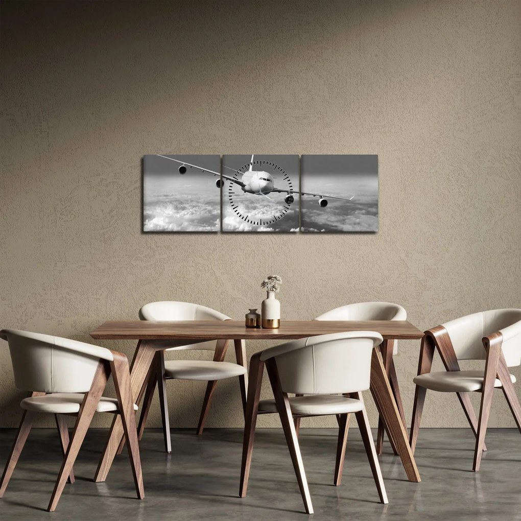 Obraz - Lietadlo v oblakoch, čiernobiele (s hodinami) (90x30 cm)