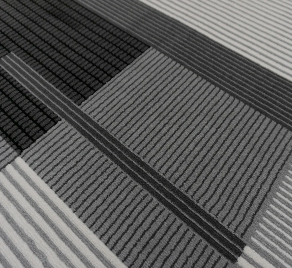 Koberec Lotus 9303 GREY – sivočierny obdĺžnikový koberec Rozmer: 240x330 cm