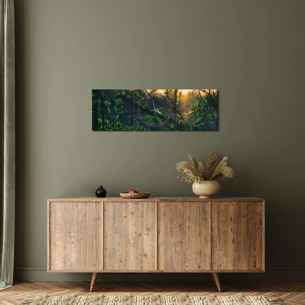 Obraz presvitajúceho slnka cez vetvičky stromov (s hodinami) (90x30 cm)