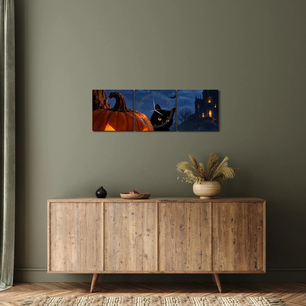 Obraz - Čierna mačka pri svietiacej tekvici na Halloween (s hodinami) (90x30 cm)