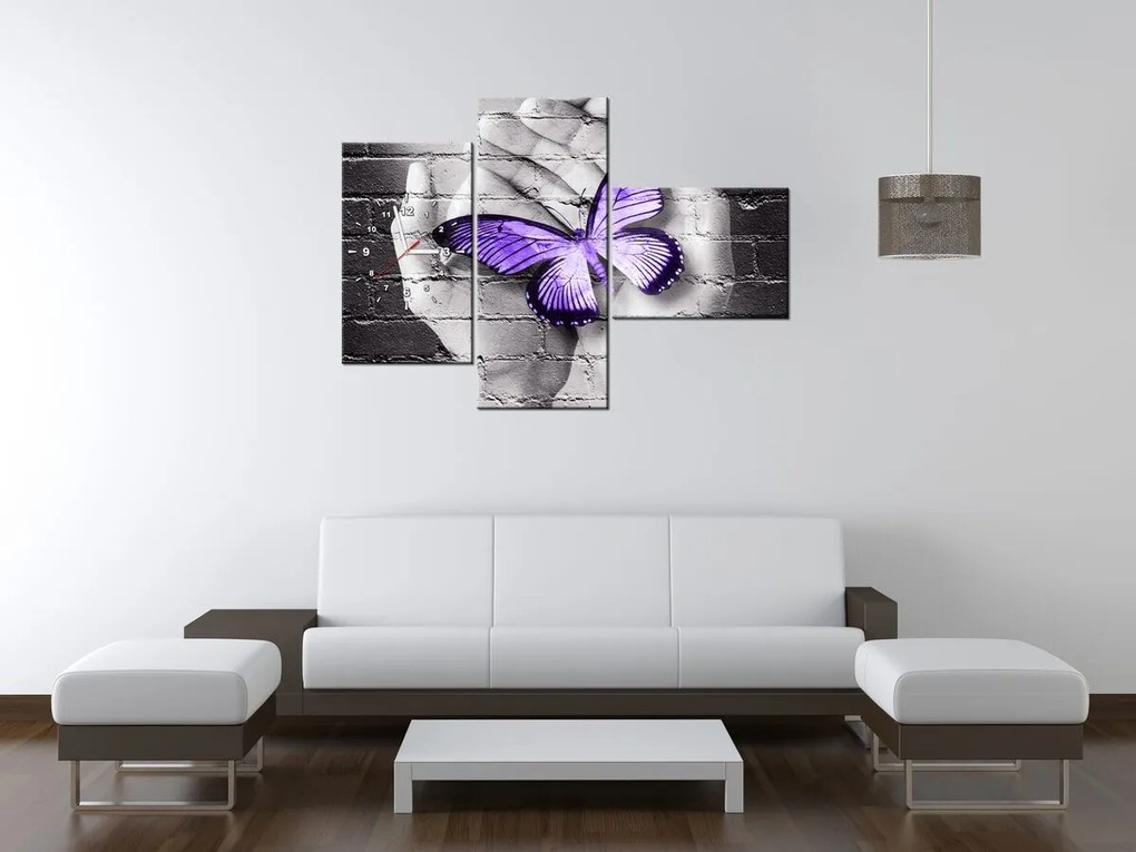 Gario Obraz s hodinami Fialový motýľ na dlaniach - 3 dielny Rozmery: 30 x 90 cm
