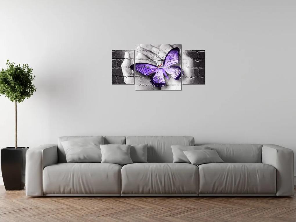 Gario Obraz s hodinami Fialový motýľ na dlaniach - 3 dielny Rozmery: 30 x 90 cm