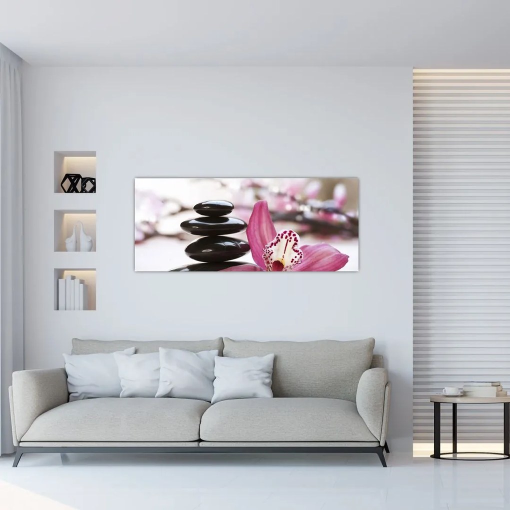 Obraz masážnych kameňov a orchidey na vode (120x50 cm)