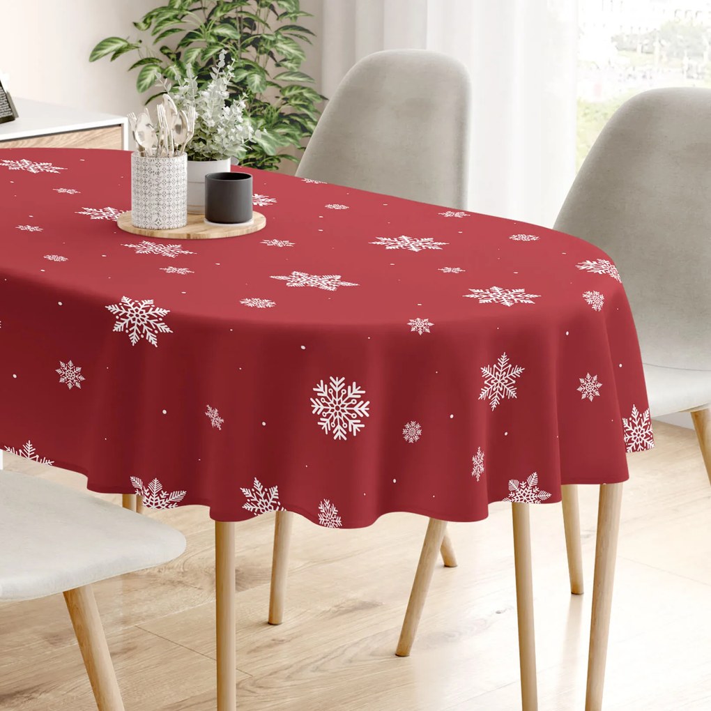Goldea vianočný oválny obrus 100% bavlnené plátno - snehové vločky na červenej 140 x 240 cm