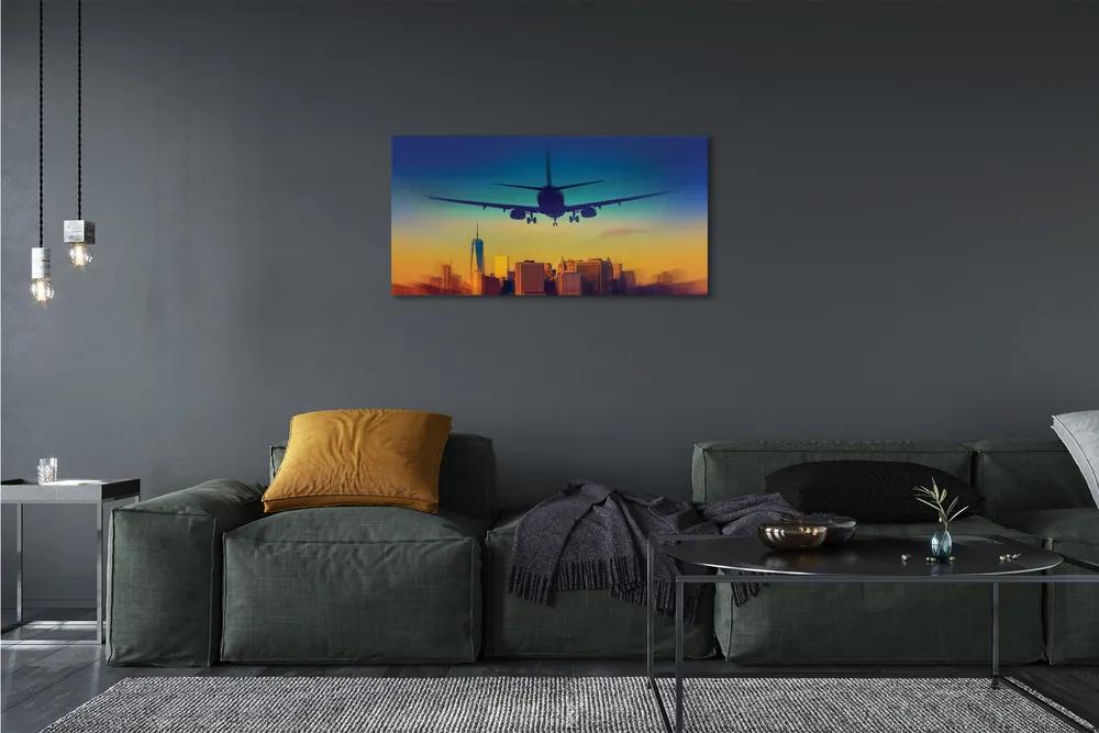 Obraz canvas Veľkomesto oblačnosti lietadlo západ 120x60 cm