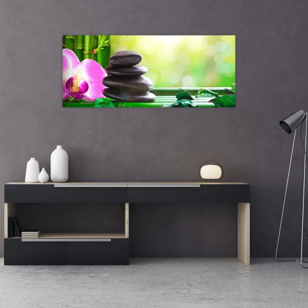 Obraz masážnych kameňov a orchidey na vode (120x50 cm)