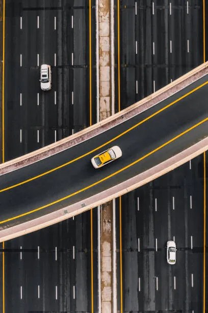 Umelecká fotografie Taxi on an overpass crossing above, Abstract Aerial Art, (26.7 x 40 cm)