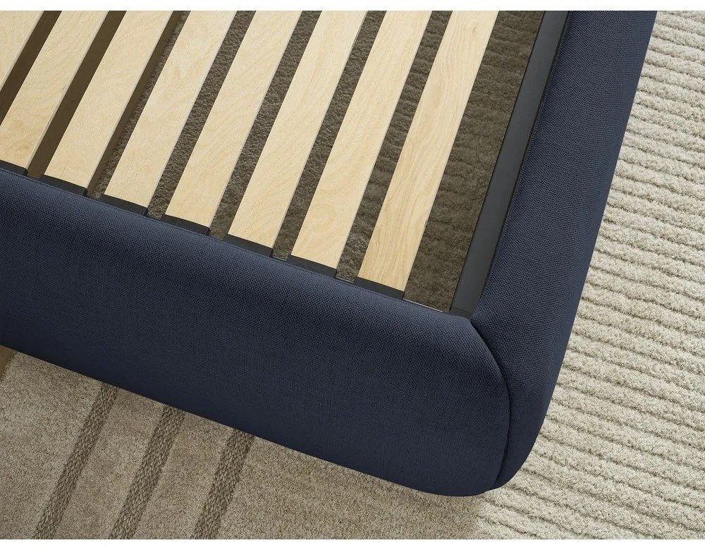 Tmavomodrá čalúnená dvojlôžková posteľ s úložným priestorom/bez čela s roštom 180x200 cm Inera – Bobochic Paris