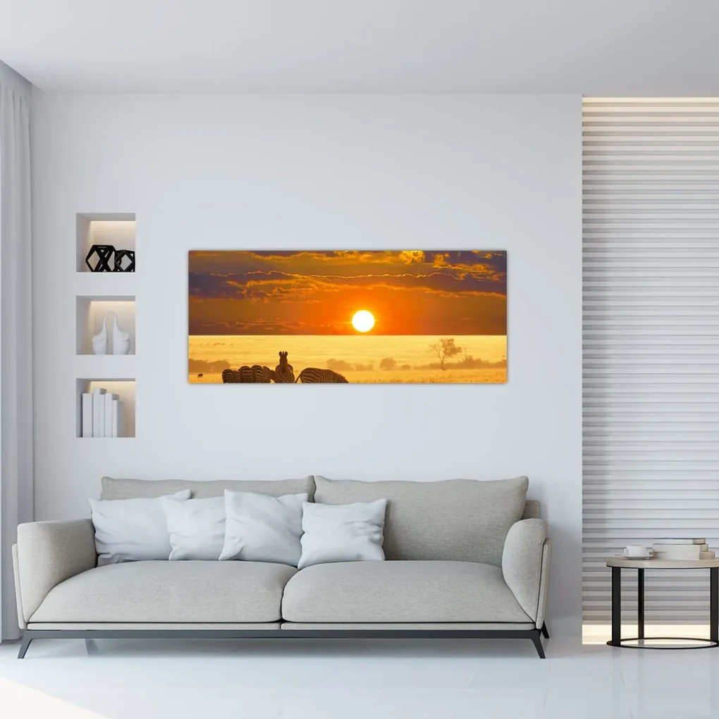 Obraz - Zebry so západom slnka (120x50 cm)