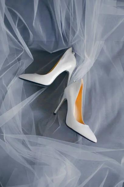 Umelecká fotografie Bride's shoes with a veil top view close-up, Artem Sokolov, (26.7 x 40 cm)